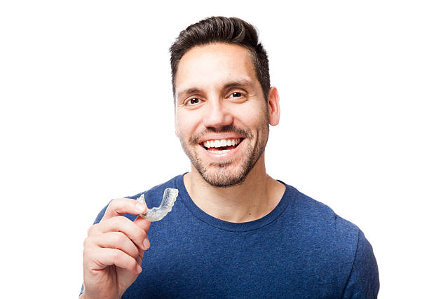 Young man wearing clear braces.