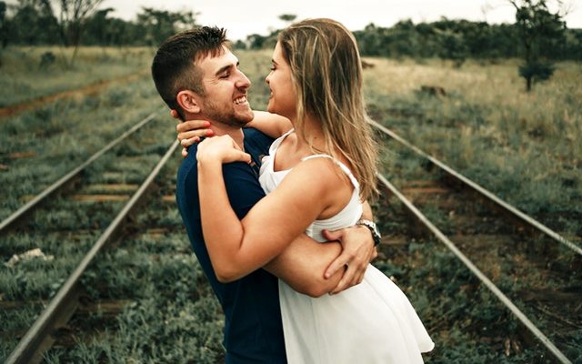 Boy and girl hugging and looking at each other