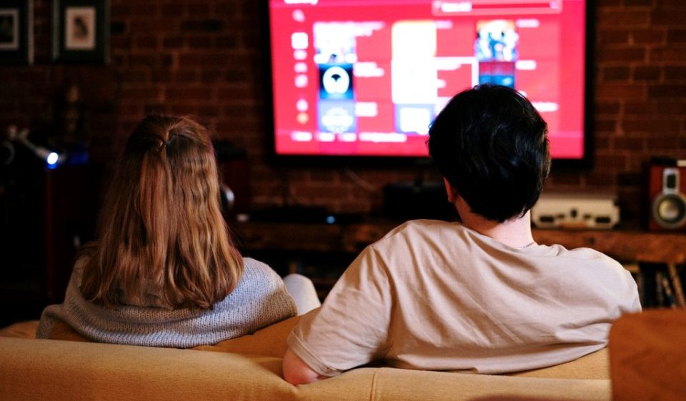 A couple watching cable TV