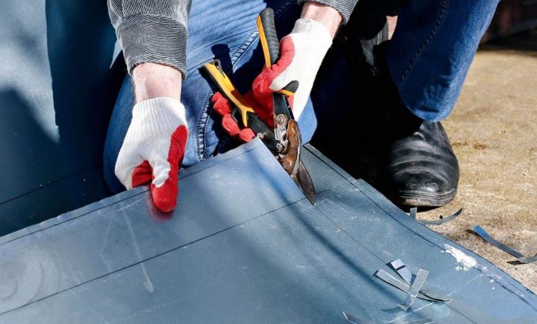 A man cutting sheet metal