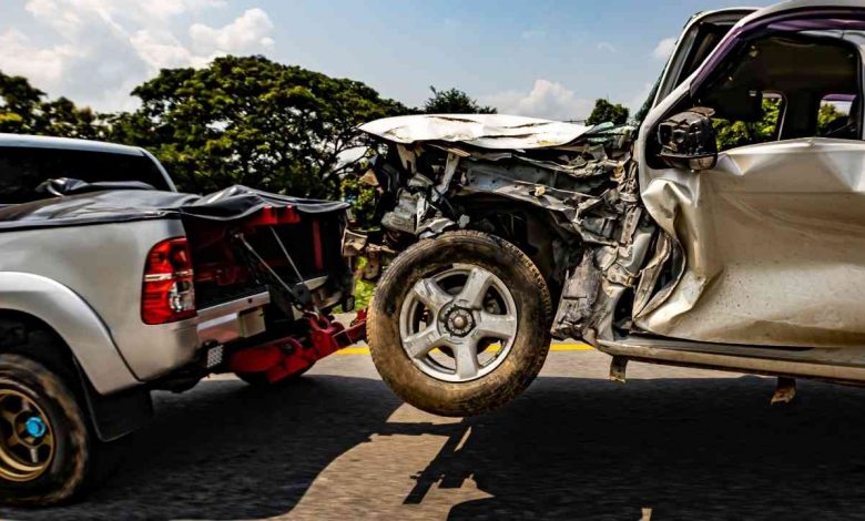 A truck towing a damaged car