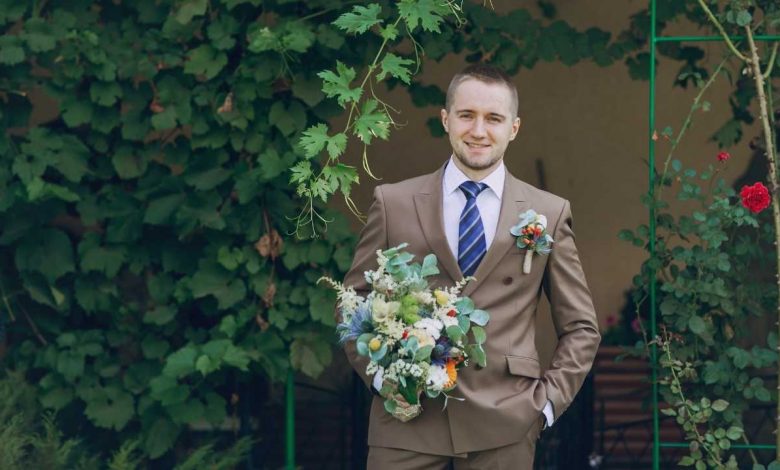 A guy wearing a suit during Summer wedding