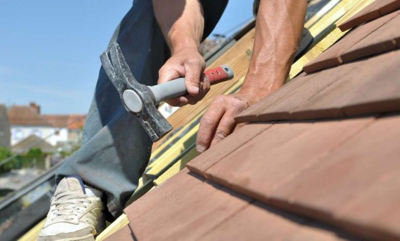 A guy working on a roof