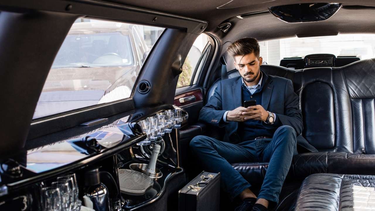 A guy sitting in a limo