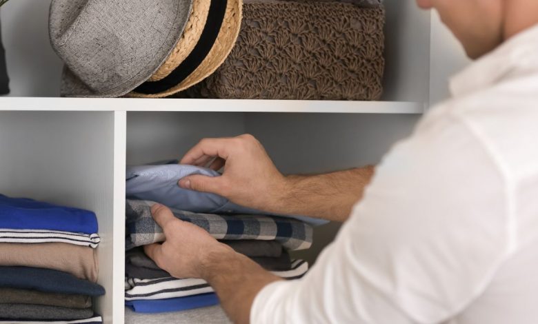 A guy organizing his closet