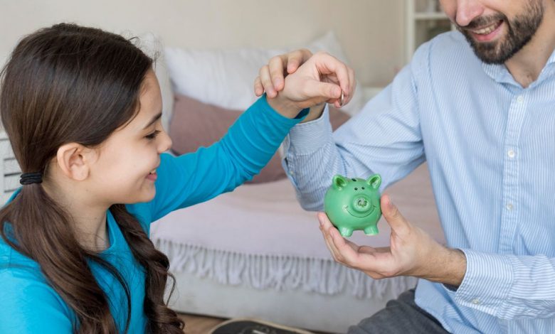 Dad teaching his daughter about money
