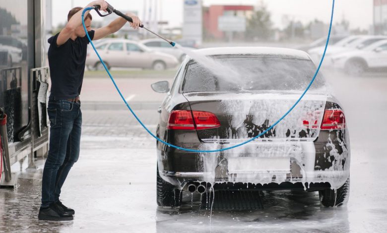 man cleaning old car