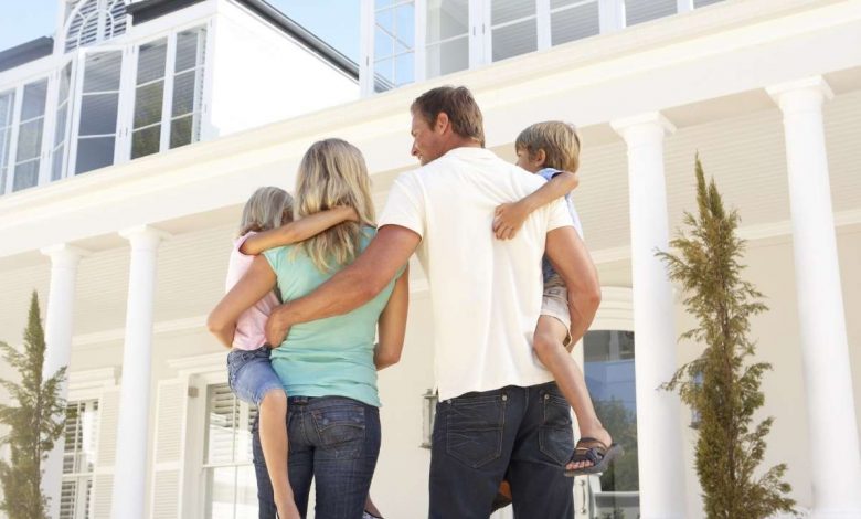 Couple in front of their home