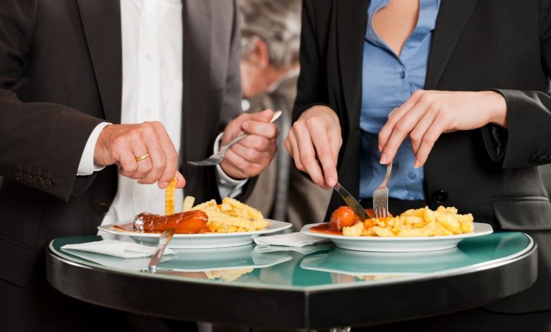 man and woman eating food