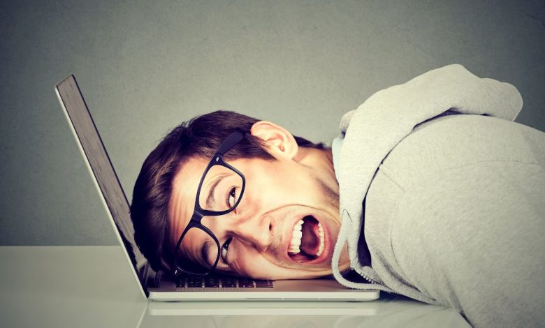 man yelling at slow laptop