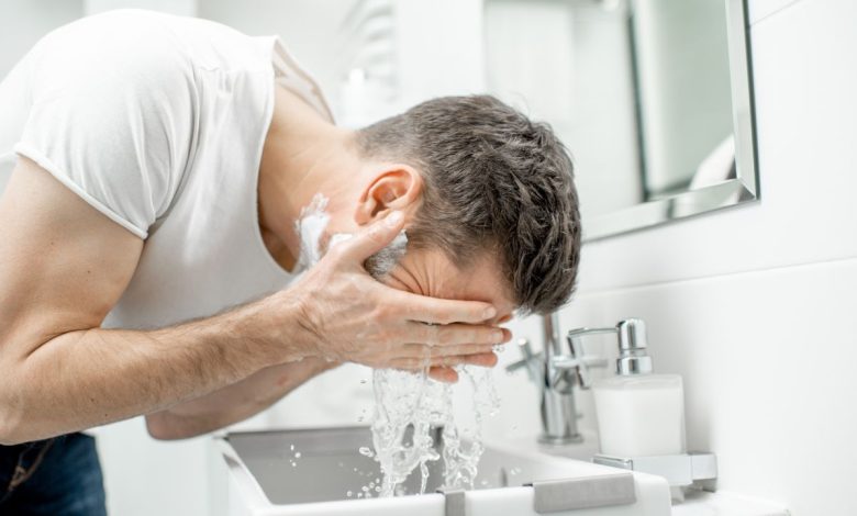 guy washing face