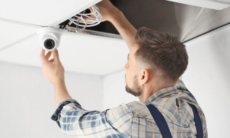 guy installing home security camera