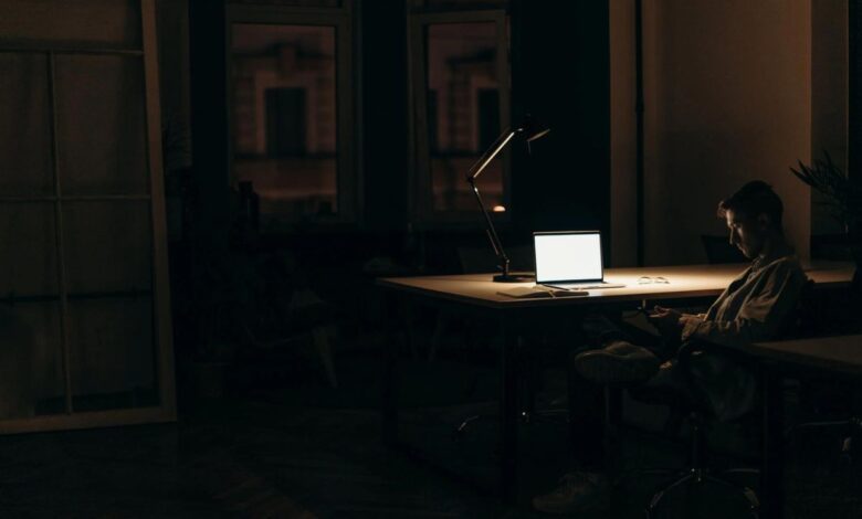 Guy using laptop at night
