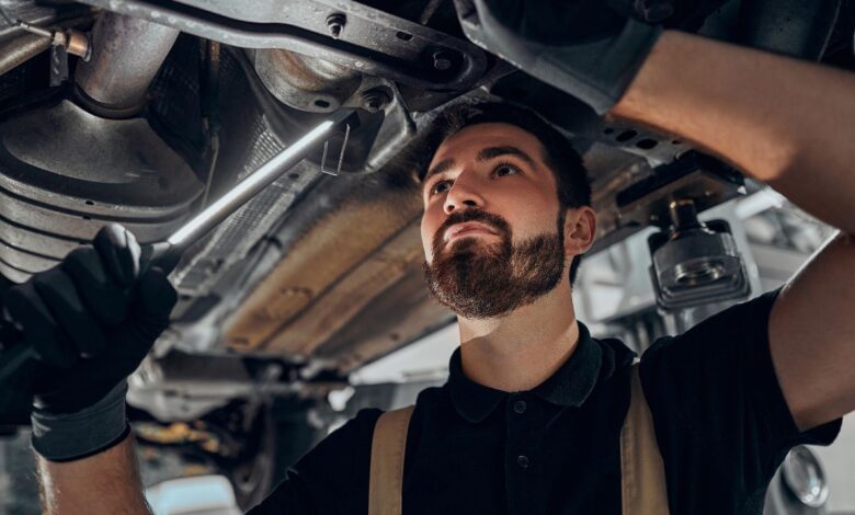 mechanic checking car suspension
