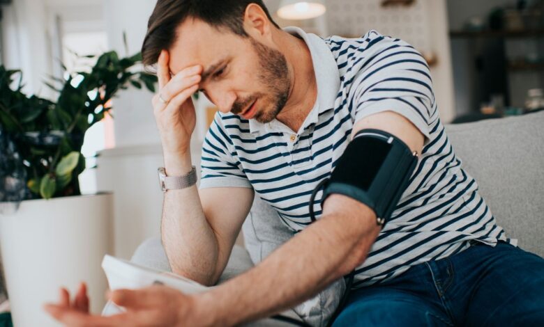 a guy checking his blood pressure