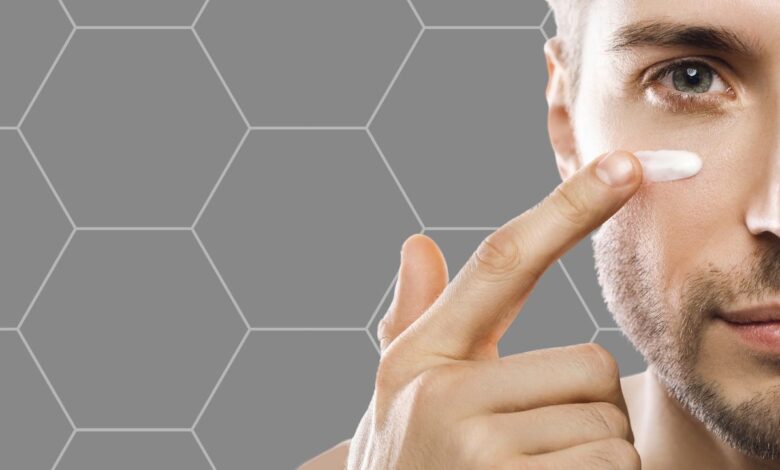 man applying moisturizing cream on face
