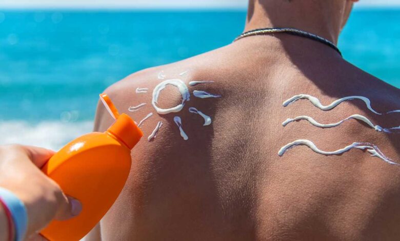 girl applying sunscreen on a mans back