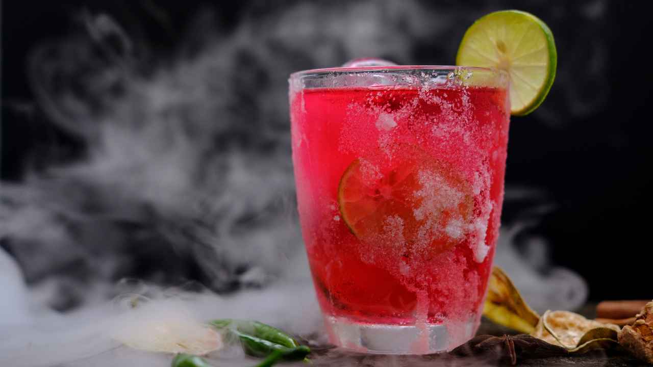 red mocktail with lemon on side