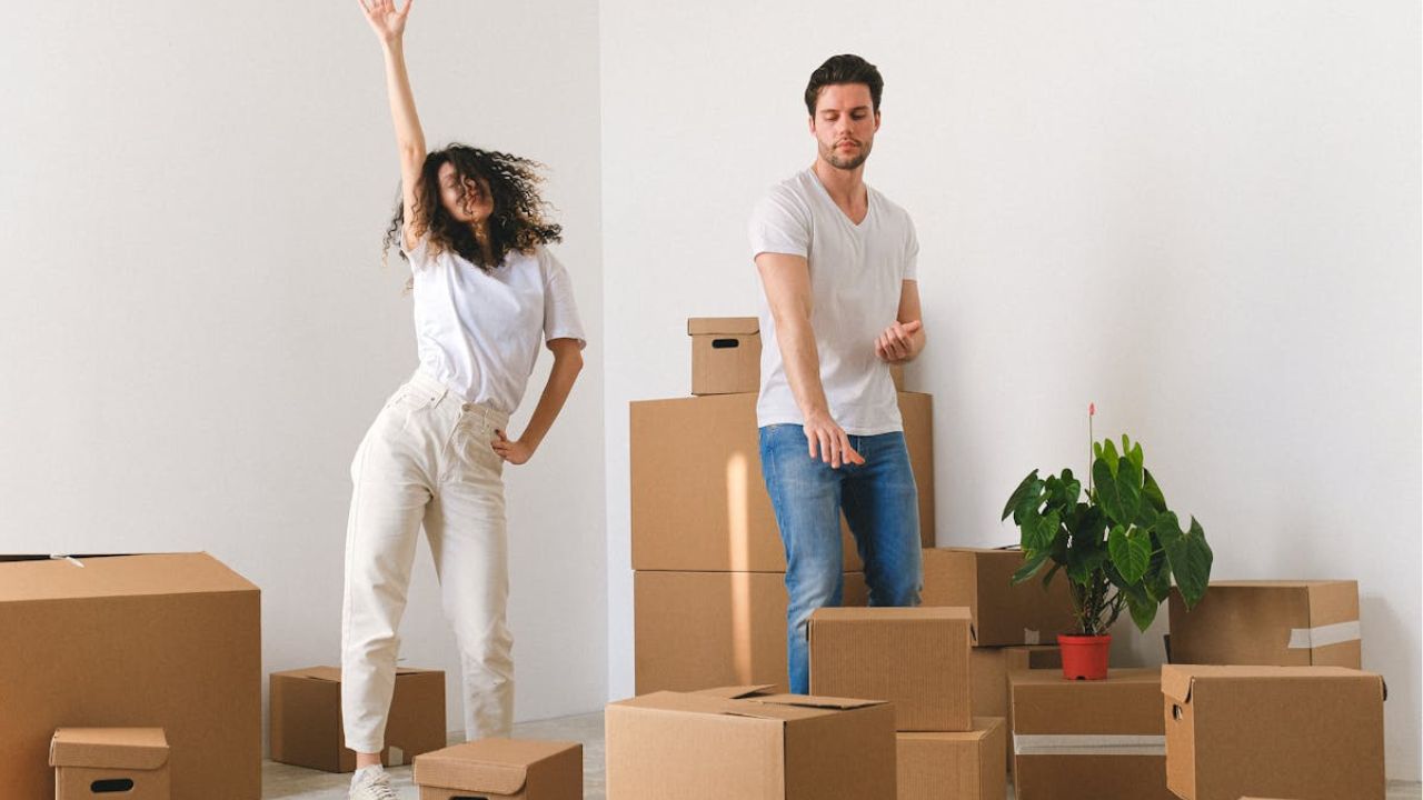 Couple dancing after buying a house