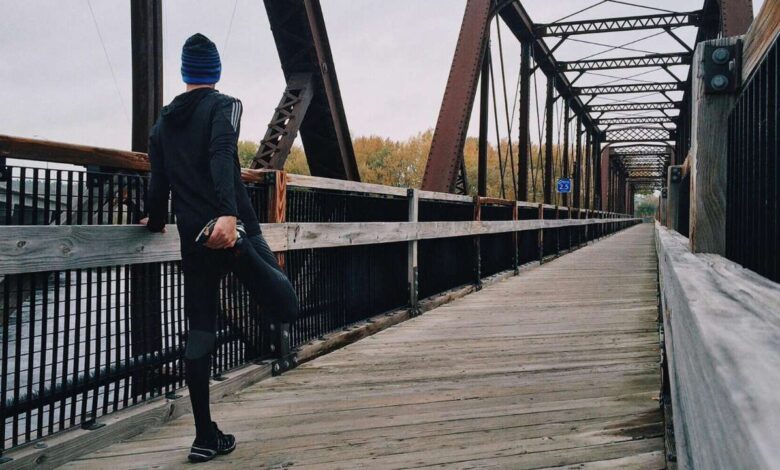 Man Standing on Bridge