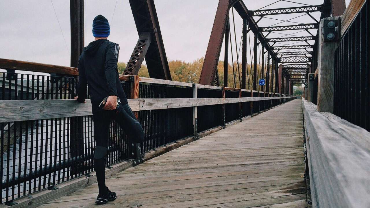 Man Standing on Bridge