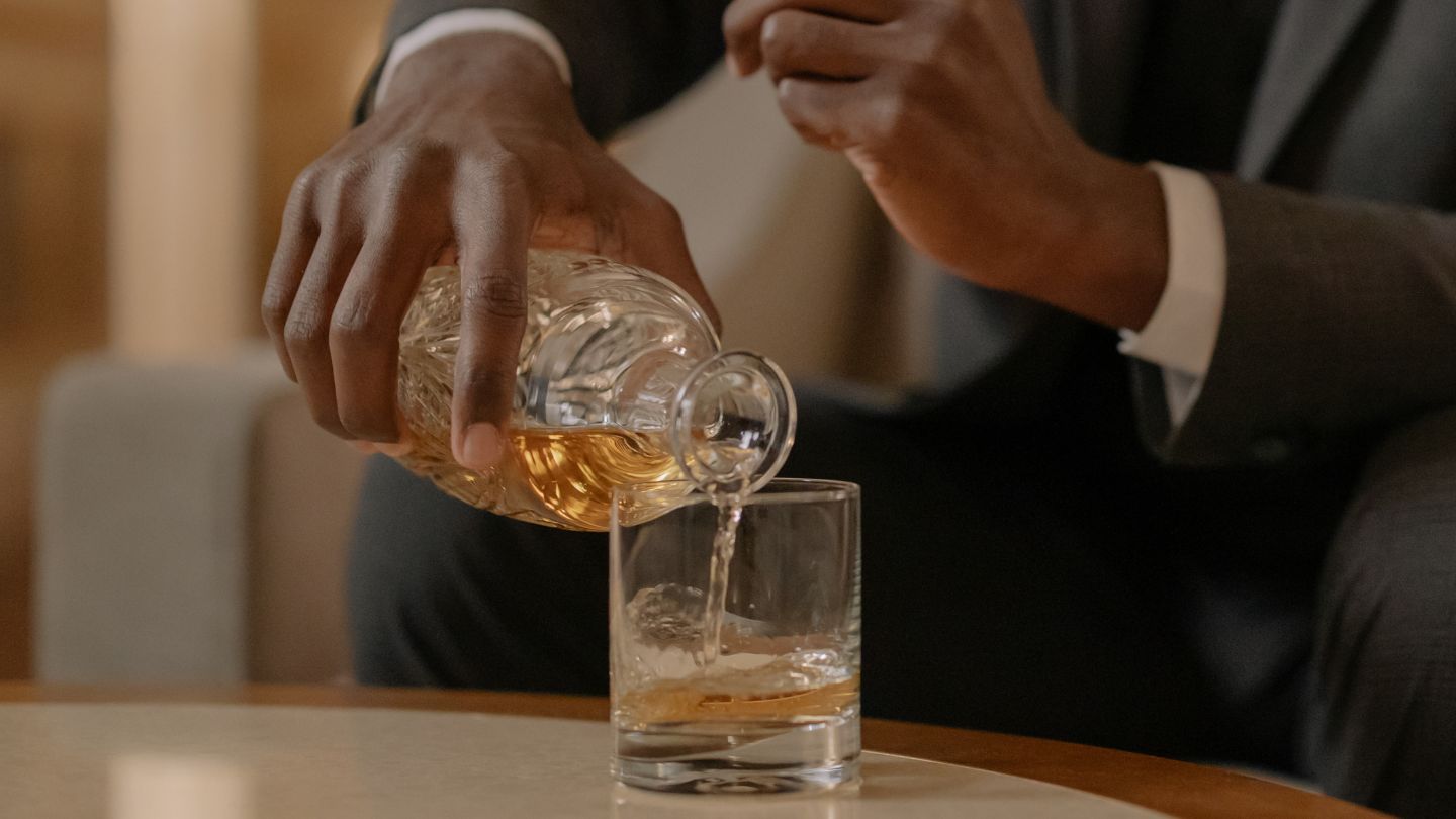 man pouring Whisky