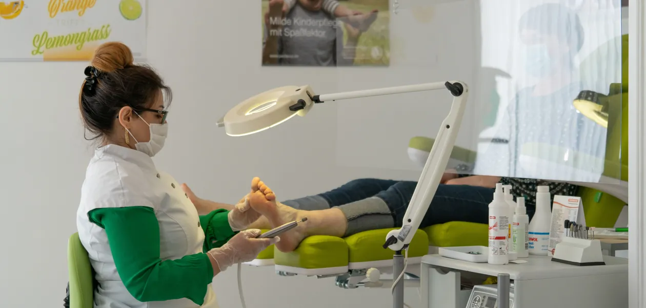 Podiatrist examining a patient's foot during a clinical exam for a persistent fungal infection