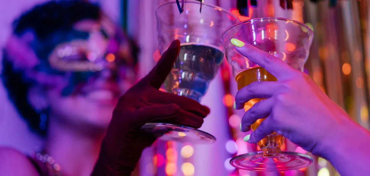 Friends clinking glasses in a toast on a big night out