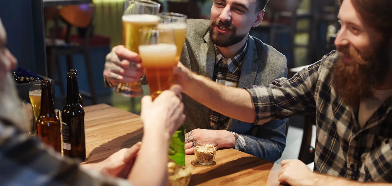 friends toasting with beer glasses at a pub