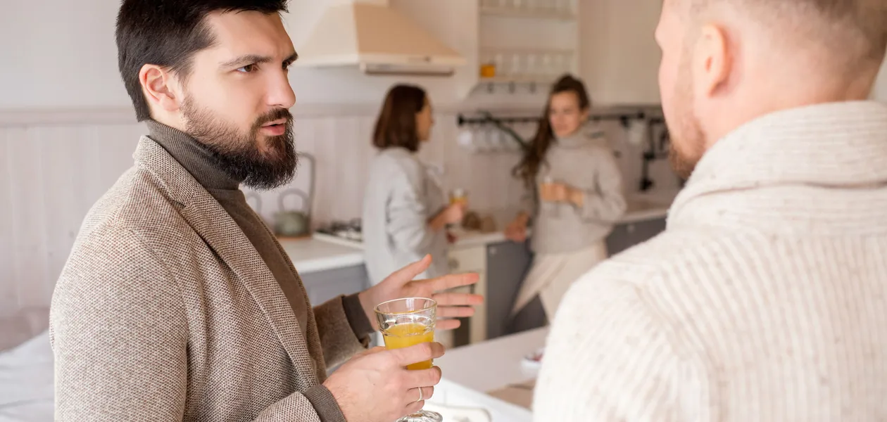 friends talking over drinks in a kitchen