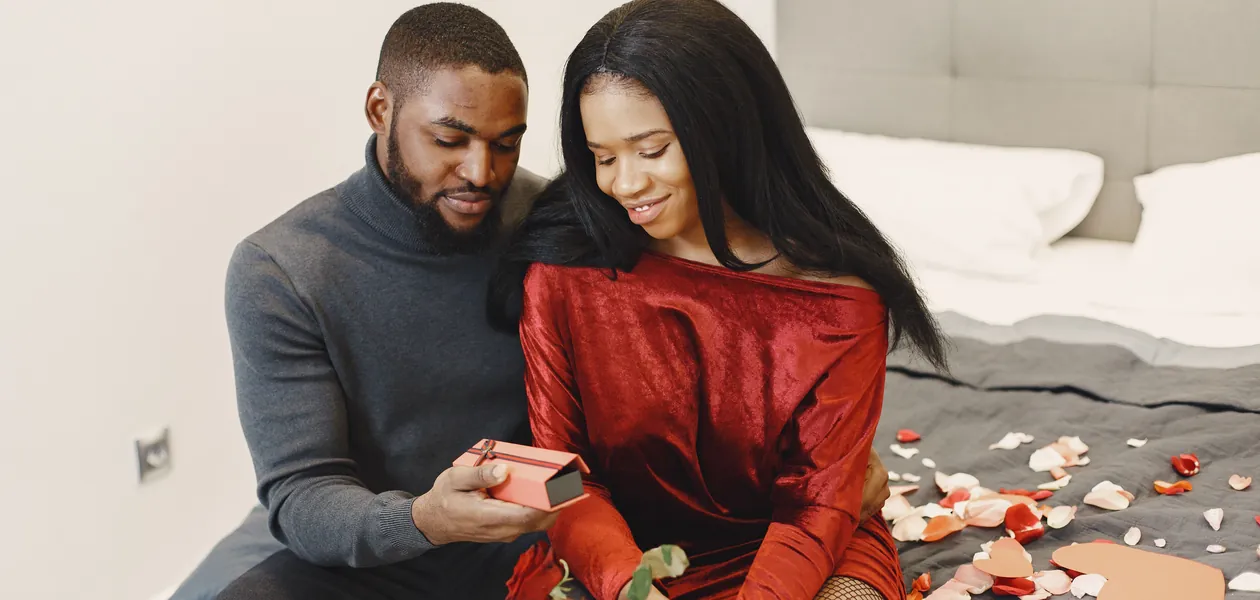 Man surprising his partner with a gift, the giving half of the exchange