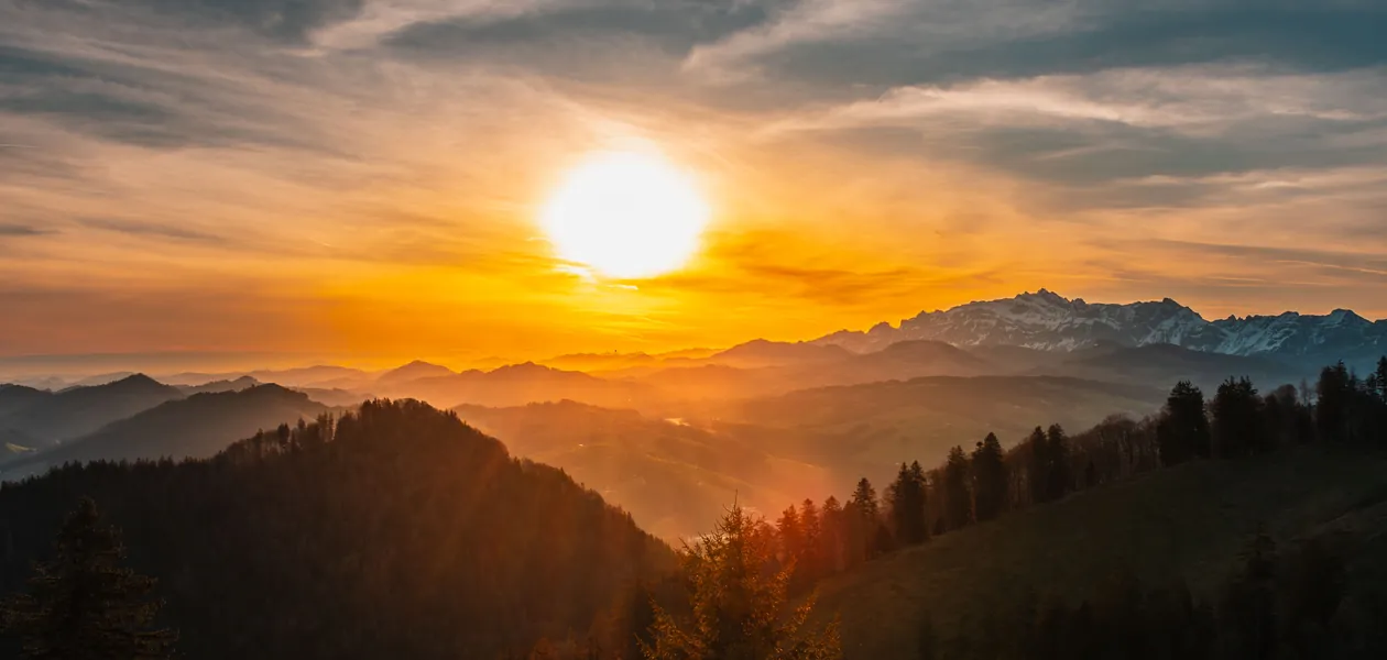 sunrise over misty mountains representing the grand rising greeting