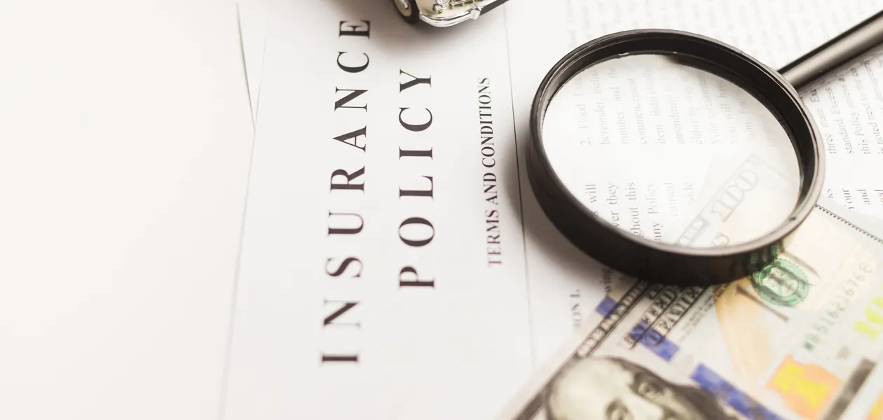 insurance policy document under a magnifying glass