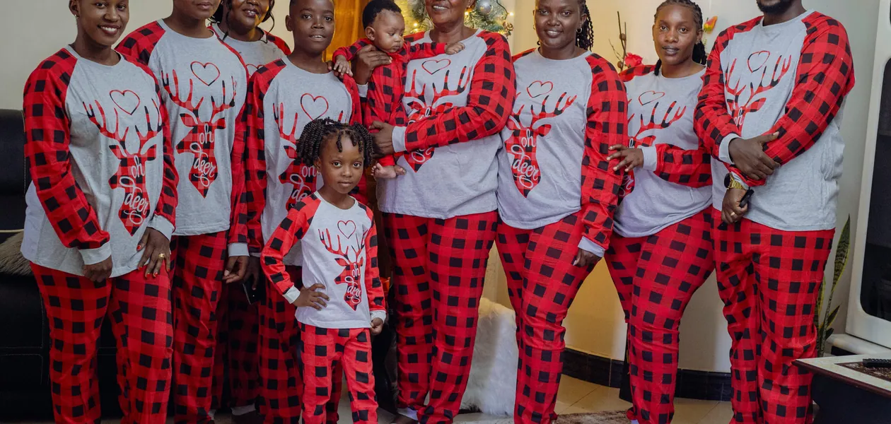 family in matching christmas pajamas opening gifts