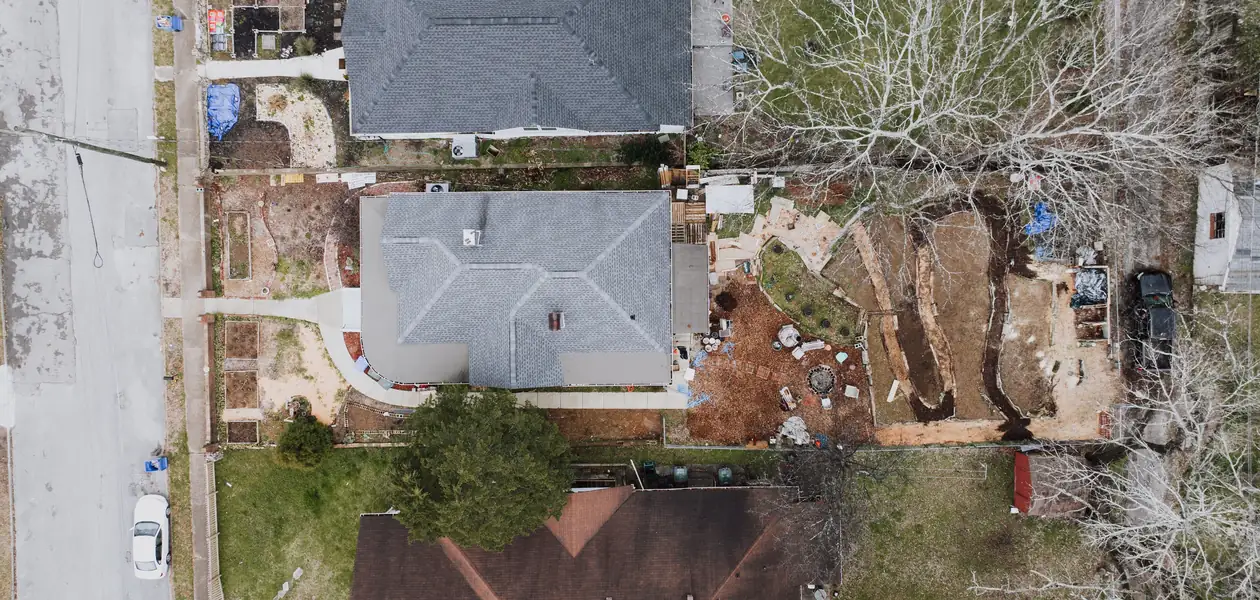 aerial view of residential backyards showing lawn and garden layout