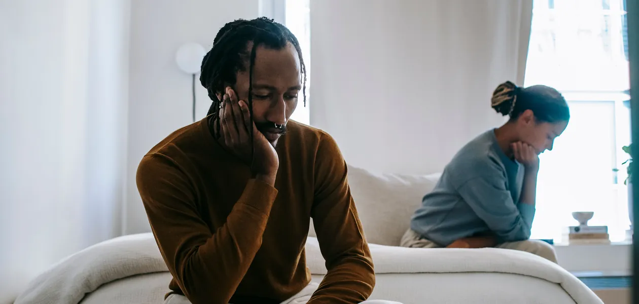 couple sitting apart facing relationship friction