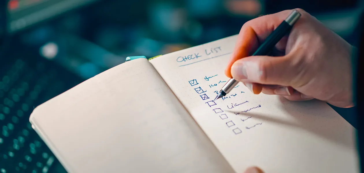 hand writing a motorcycle backpack buying checklist
