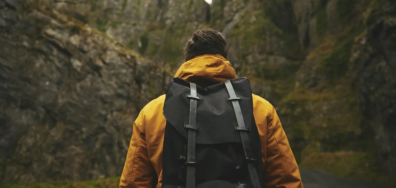 man wearing an adventure backpack outdoors