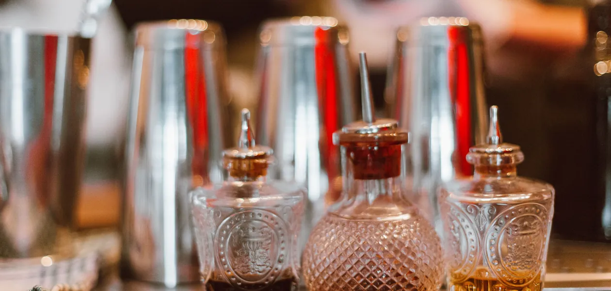 bottles of non-alcoholic bitters on a bar counter