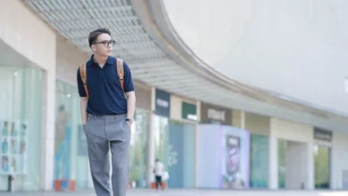 man posing for a mens ootd photo on a city street