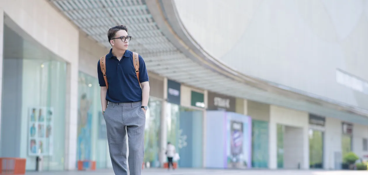 man posing for a mens ootd photo on a city street