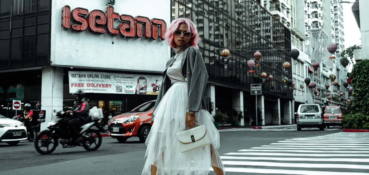 woman photographing her outfit of the day in the city