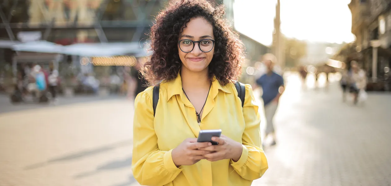 Woman smiling at a sweet text on her phone